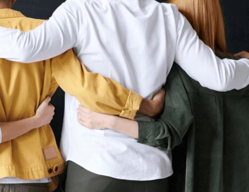 People supporting each other with their arms around one another